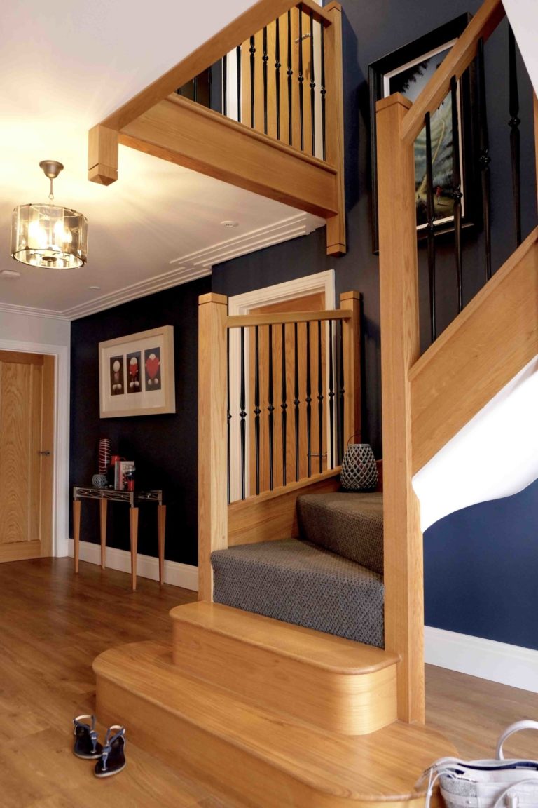 Accent wall with blue paint and oak staircase