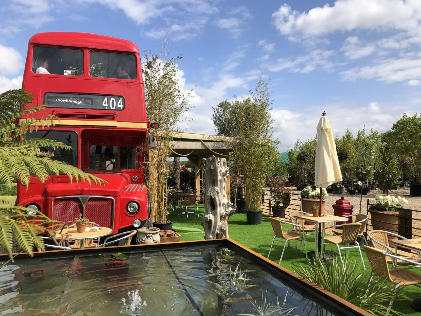 There is plenty of seating on the bus inside upstairs and a fully equipped kitchen. The bus also has a stunning outside space in the sunshine surrounded by the gorgeous Essex countryside. Tables and chairs are laced with potted plants whilst horses graze in the distance.