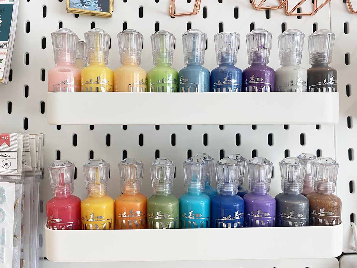 Ikea Skadis shelf on pegboard filled with Nuvo dots tonic studios in rainbow colours