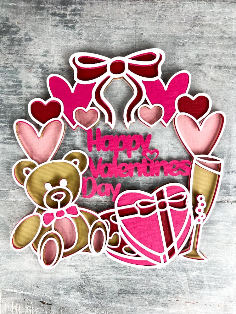 Stunning Happy Valentines SVG layered cut file free to download. With teddy, champagne, chocolates and hearts