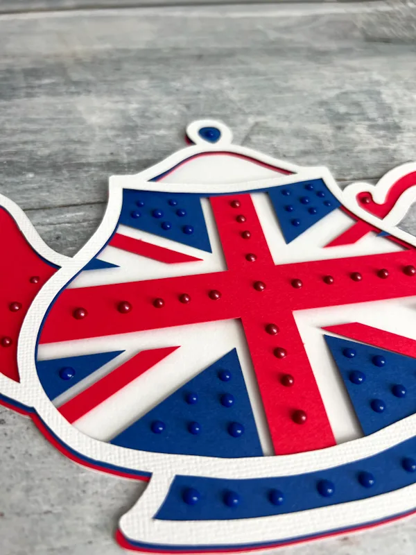 close up of British Union Jack teapot paper cut with novo dots on