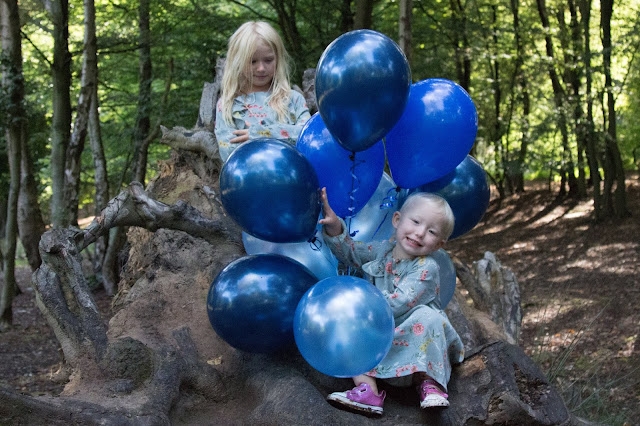Children with Blue balloons for a gender reveal party