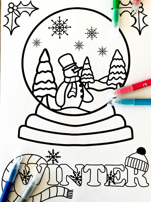 Christmas snow globe winter themed colouring page filled with a friendly snowman, snow covered trees, holly, scarf and wooly hat to colour in