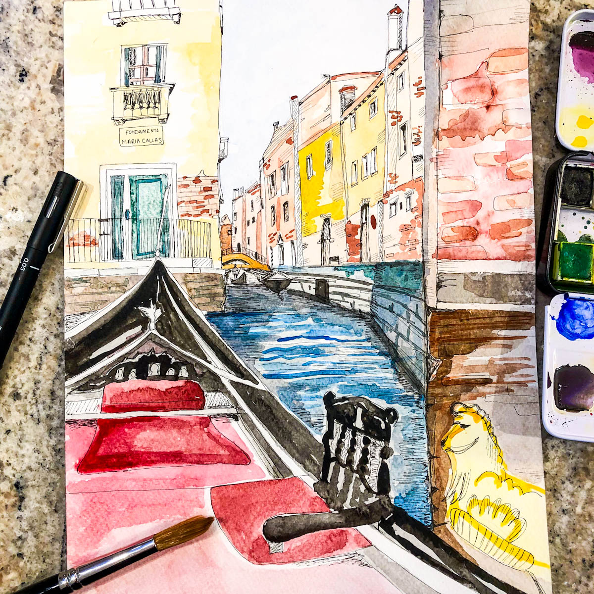 A watercolour painting of Venice in a travel journal