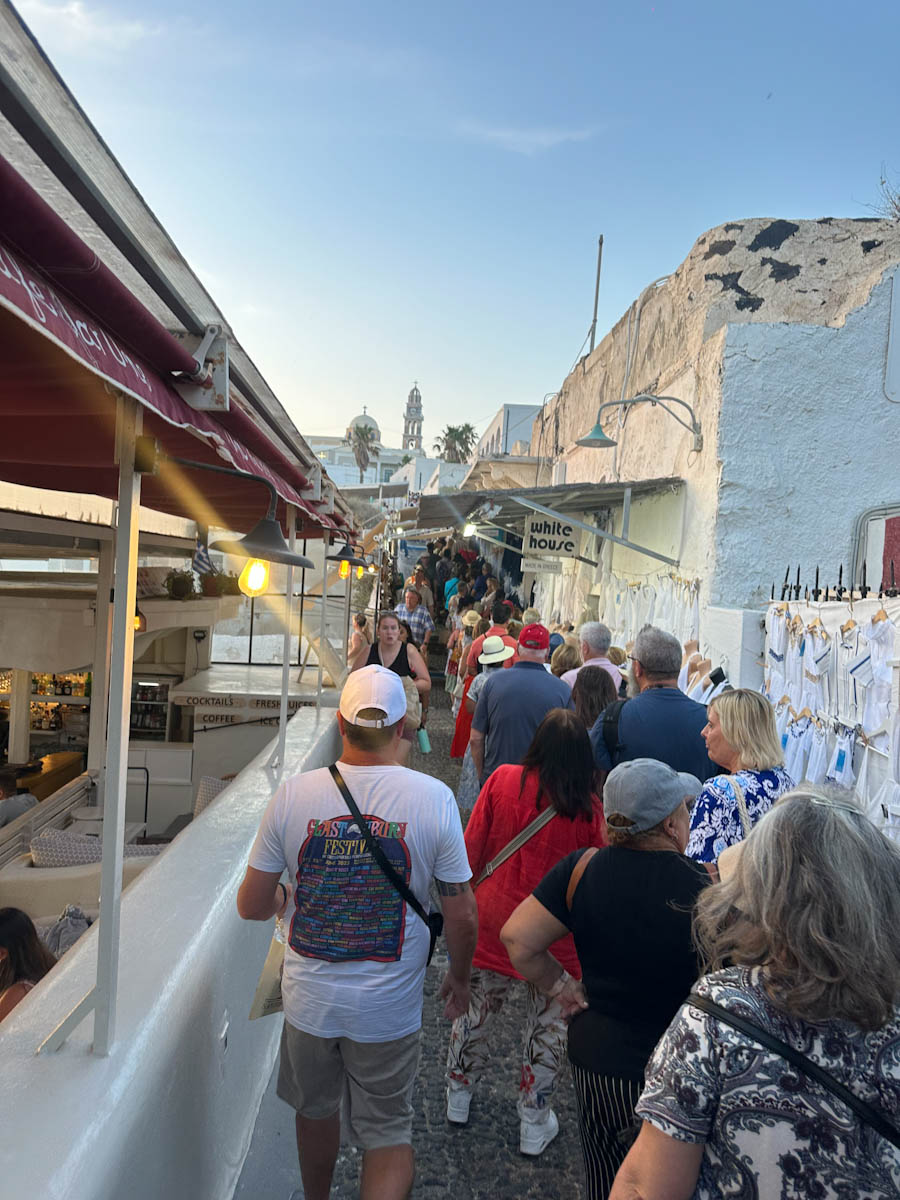 Busy Thira streets in Santorini waiting for the cable car