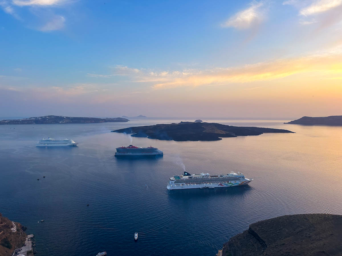 A Virgin Cruise ship, an NCL Cruise ship and a Royal Caribbean cruise ship tendered in the bay of Santorini.